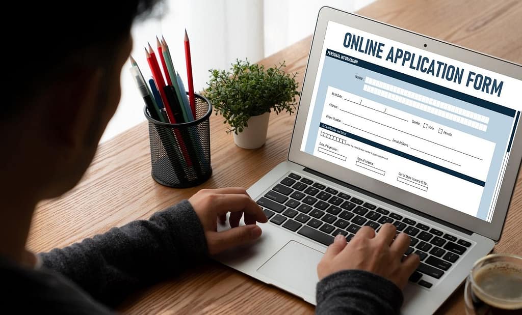 Image of an international student filling in a university application form online.